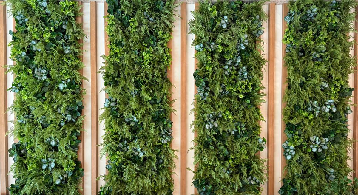 Close-up of artificial plant wall planter flat back showing zero gap between frame and wall surface